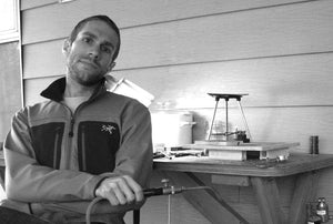 Austin Moore Sits at his bench in his first studiom housed on his back porch, in 2009